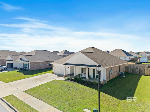 ranch-style home with central AC, a front lawn, covered porch, and a garage