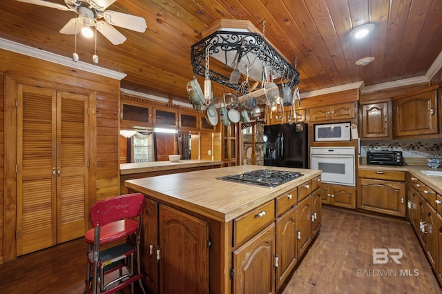 kitchen with wood ceiling, a center island, dark wood-type flooring, and white appliances