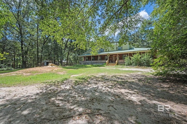 view of yard featuring covered porch