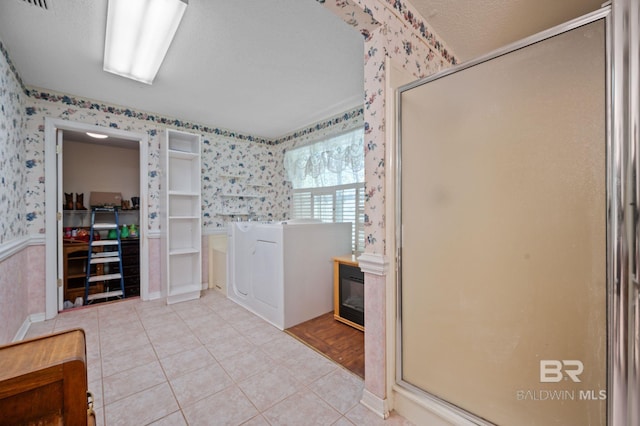 bathroom with tile patterned floors and walk in shower