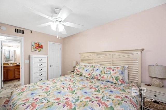 bedroom with ensuite bath, ceiling fan, and sink