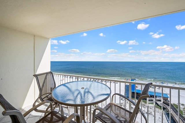 balcony with a beach view and a water view