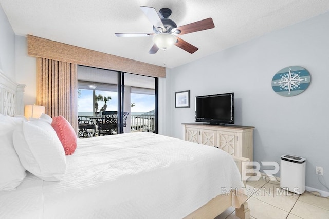 tiled bedroom featuring ceiling fan, access to outside, and a textured ceiling