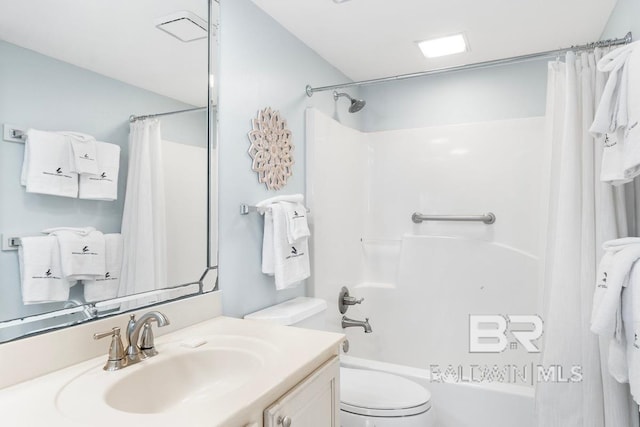 full bathroom featuring shower / bathtub combination with curtain, toilet, and vanity