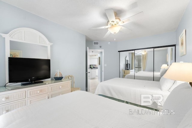 bedroom featuring a closet, ceiling fan, and light tile floors