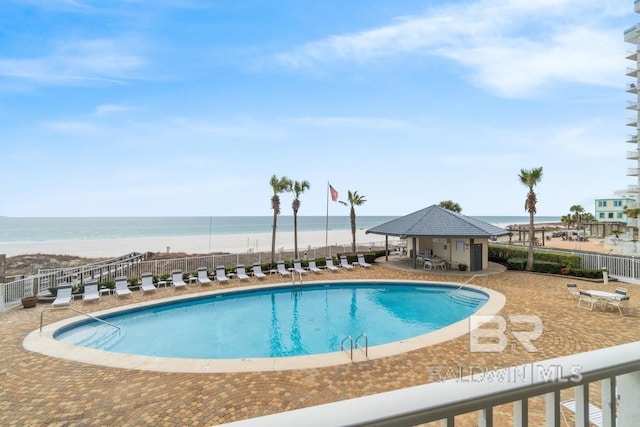 view of pool with a patio area and a water view