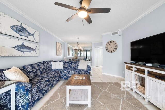 living room with ceiling fan with notable chandelier, a textured ceiling, light tile flooring, and ornamental molding