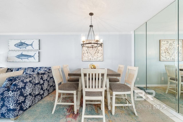 dining area with crown molding and a chandelier