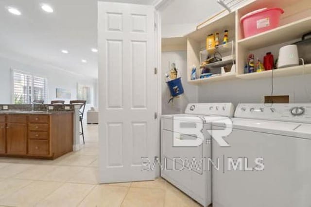 200 Peninsula Blvd Unit E101, Gulf Shores, AL 36542 - laundry room with washing machine and dryer, light tile patterned floors, and recessed lighting