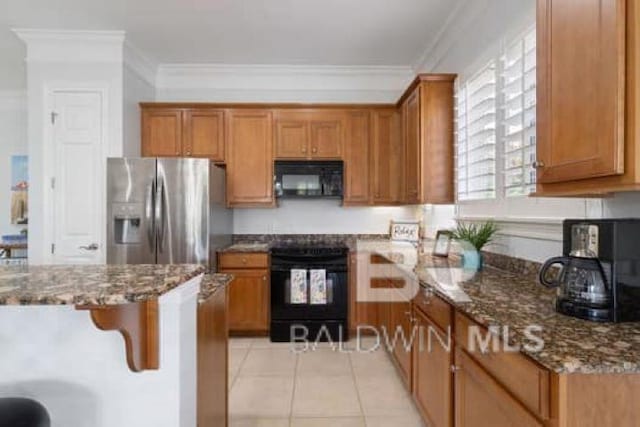 200 Peninsula Blvd Unit E101, Gulf Shores, AL 36542 - kitchen featuring stainless steel fridge, black microwave, stove, brown cabinetry, and crown molding