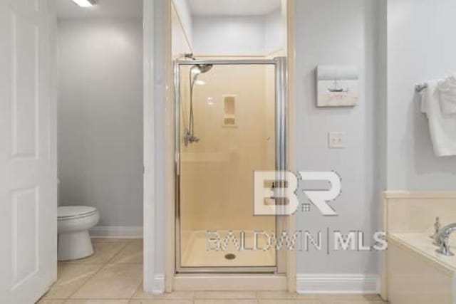 200 Peninsula Blvd Unit E101, Gulf Shores, AL 36542 - full bathroom with a shower stall, toilet, tile patterned floors, and a garden tub