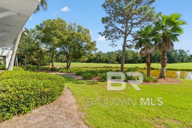 200 Peninsula Blvd Unit E101, Gulf Shores, AL 36542 - view of community with a lawn, a water view, and view of wooded area