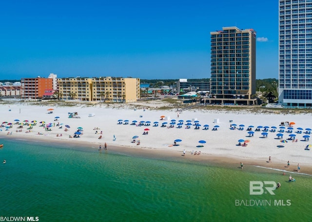 birds eye view of property with a view of the beach and a water view