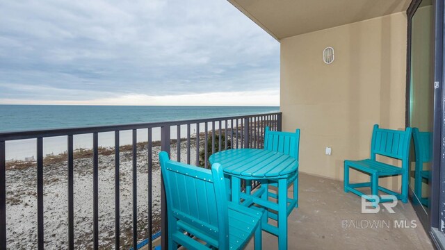 balcony with a view of the beach and a water view