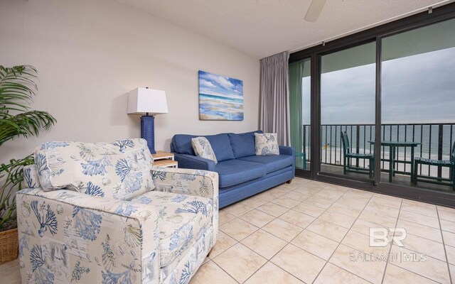 living room featuring floor to ceiling windows and light tile patterned floors