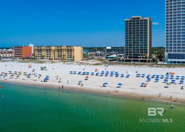 birds eye view of property featuring a beach view and a water view