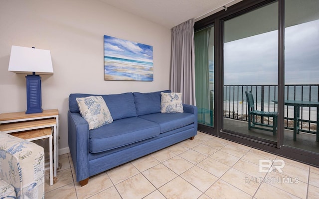 living room with a water view and light tile patterned floors