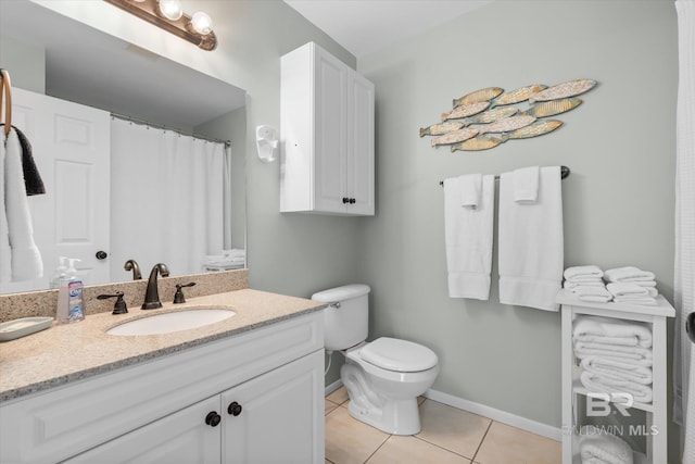 bathroom with tile patterned flooring, vanity, and toilet