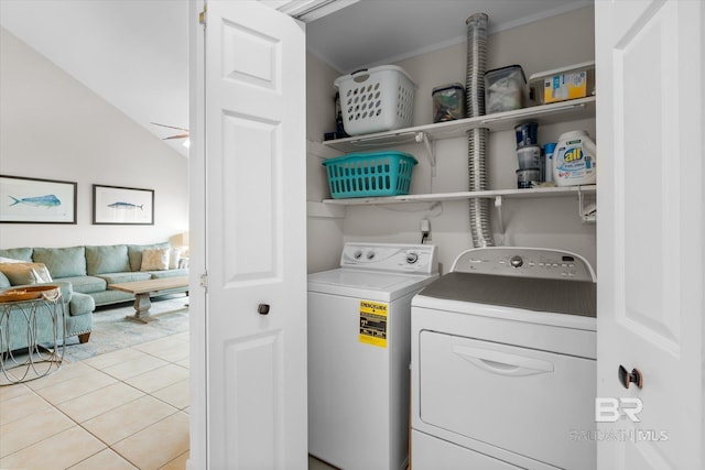 laundry area with separate washer and dryer and light tile patterned floors