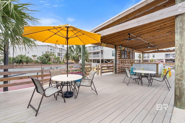 wooden terrace featuring ceiling fan