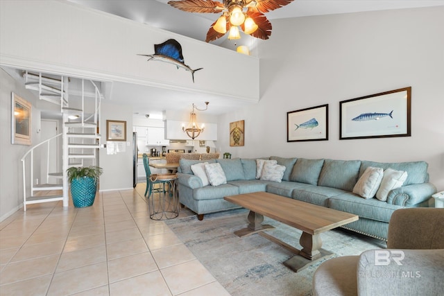 tiled living room featuring ceiling fan with notable chandelier