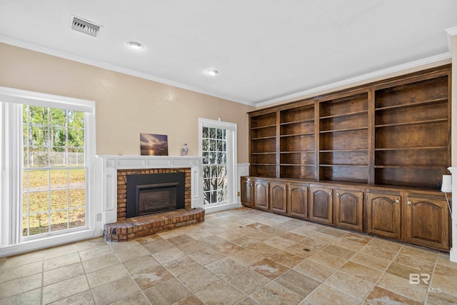 unfurnished living room featuring a brick fireplace and crown molding