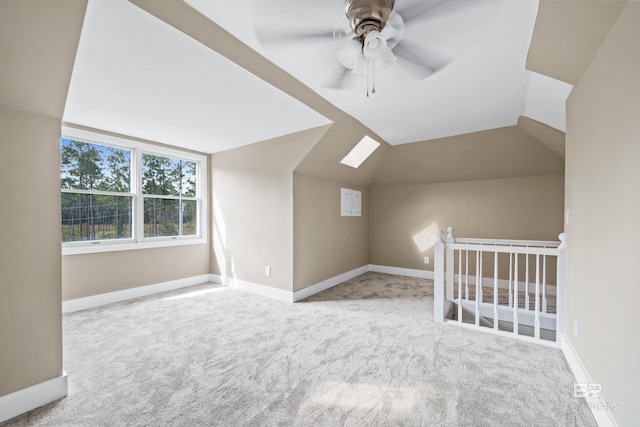 bonus room featuring carpet, ceiling fan, and lofted ceiling with skylight