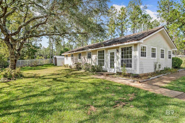 view of front of property with a front lawn and a storage unit