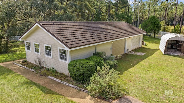 view of side of home featuring a carport and a yard