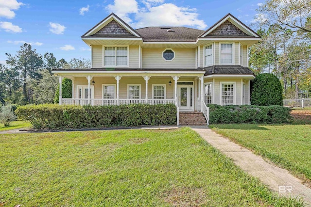 view of front of house with a front yard and a porch