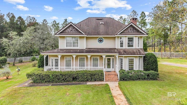 view of front of property with a porch and a front lawn