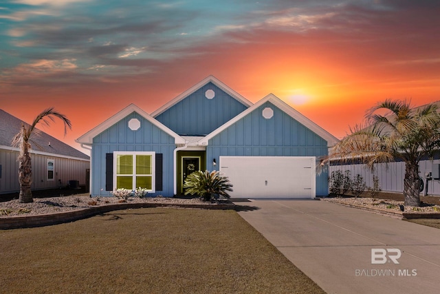 view of front of house with a garage and a lawn