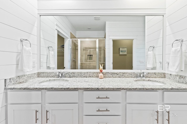 bathroom featuring an enclosed shower and vanity