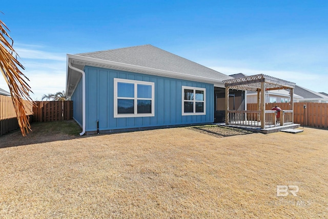 back of property featuring a lawn and a pergola