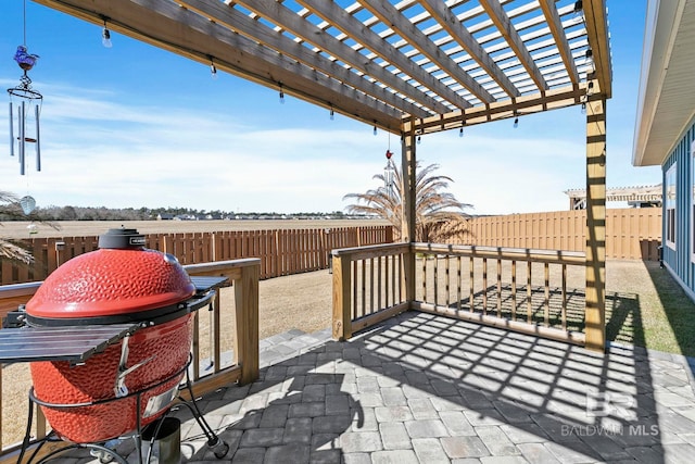 view of patio with a grill and a pergola