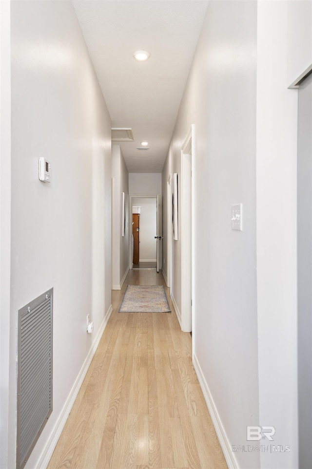 hallway featuring recessed lighting, visible vents, light wood-style flooring, and baseboards