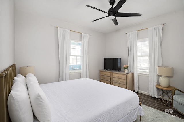 bedroom featuring ceiling fan, wood finished floors, and baseboards