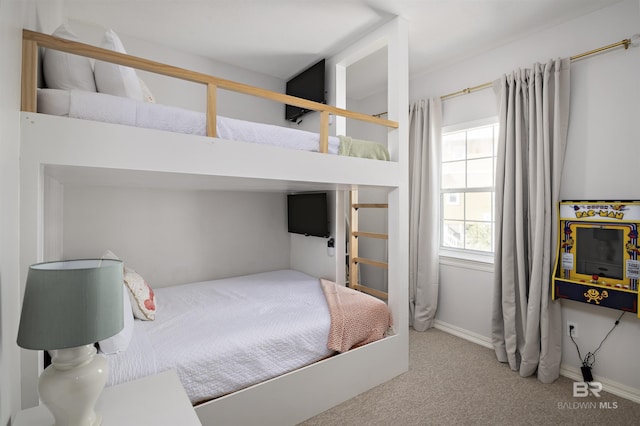 bedroom featuring carpet and baseboards