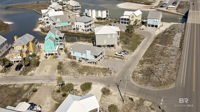 drone / aerial view featuring a water view and a residential view