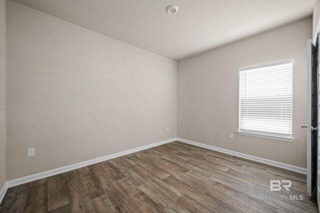 24154 Veranda Cir, Elberta, AL 36530 - spare room featuring dark wood-style flooring and baseboards