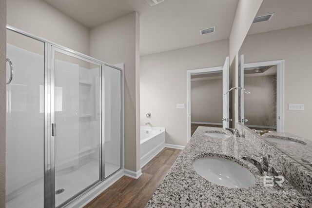 24154 Veranda Cir, Elberta, AL 36530 - full bathroom featuring wood finished floors, a stall shower, a bath, double vanity, and baseboards