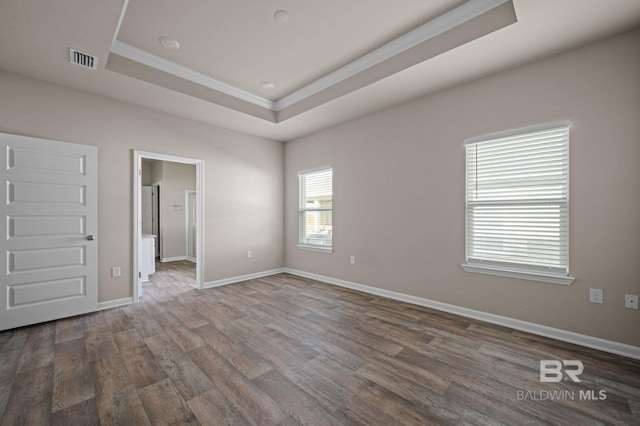 24154 Veranda Cir, Elberta, AL 36530 - unfurnished bedroom featuring a tray ceiling, crown molding, dark wood-type flooring, and baseboards