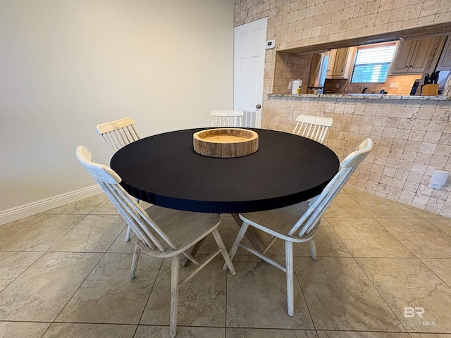 unfurnished dining area featuring tile patterned floors and baseboards