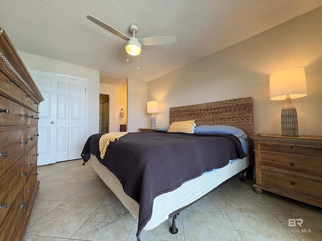 bedroom featuring a textured ceiling, a closet, and ceiling fan