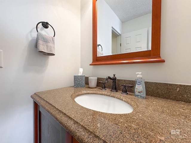 bathroom featuring vanity and a textured ceiling