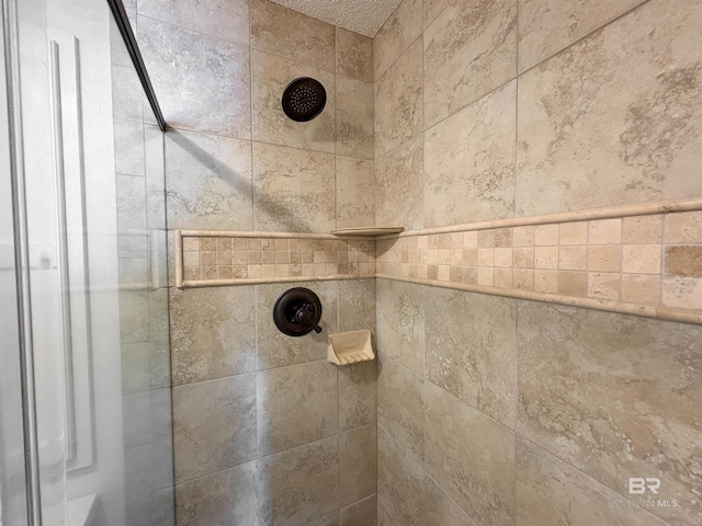 interior details featuring a tile shower