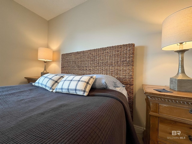 bedroom featuring lofted ceiling