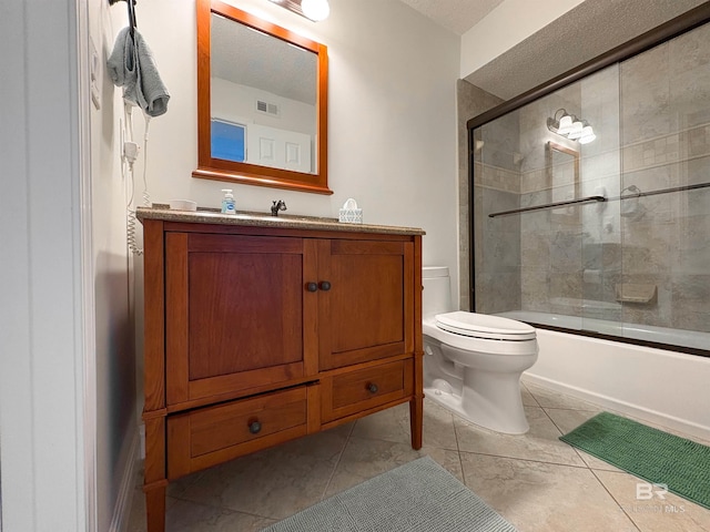 bathroom featuring visible vents, toilet, tile patterned flooring, enclosed tub / shower combo, and vanity