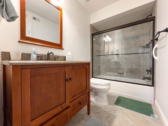 full bathroom featuring toilet, visible vents, bath / shower combo with glass door, and a textured ceiling