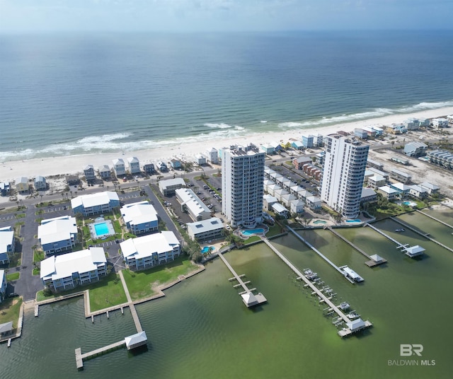 birds eye view of property with a water view, a view of city, and a view of the beach